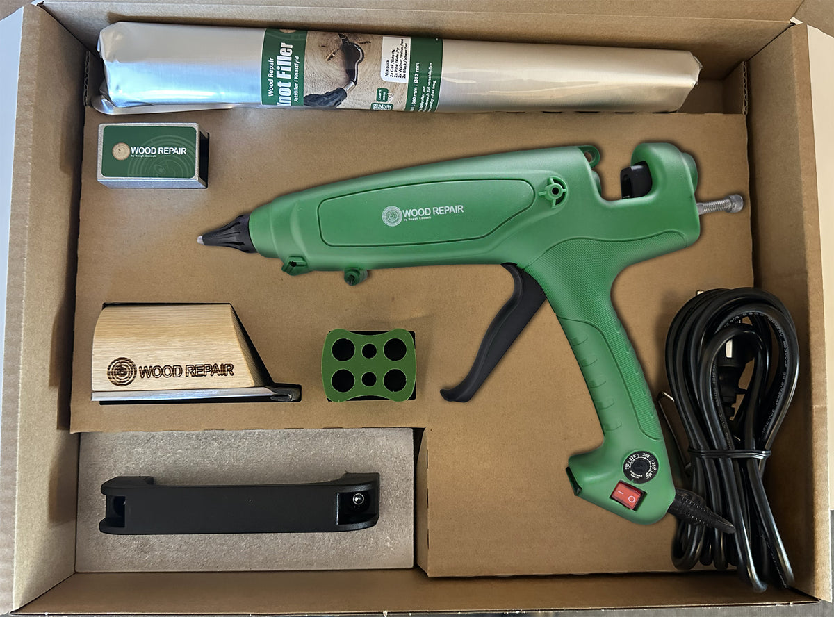 Wood Repair PRO Kit open case with the WR 360 gun, Knot Filler sticks, cooling iron, brick, cutting tool and saver laid out