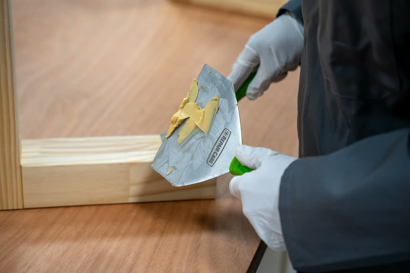 Repair Care two-component filler loaded on an EASY-Q knife during a wooden window frame repair