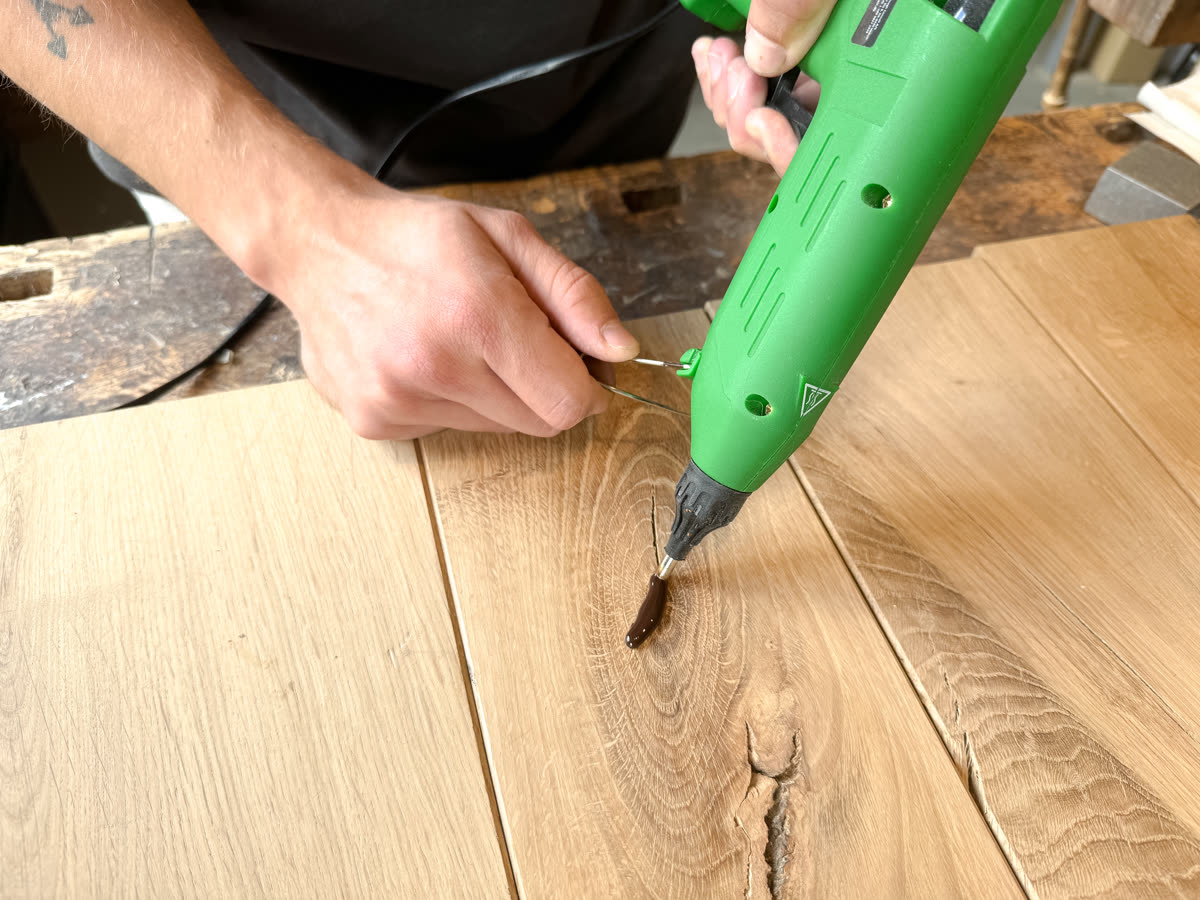 Wood Repair step 1, Fill: Melt the filler straight into the crack.